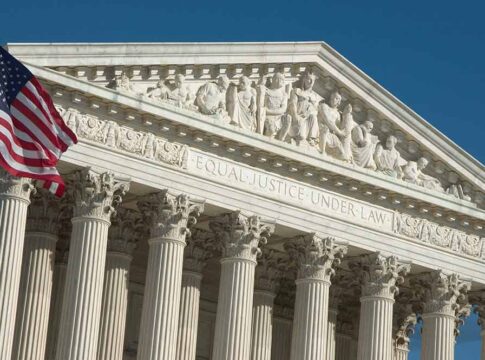 Supreme Court building facade with American flag.