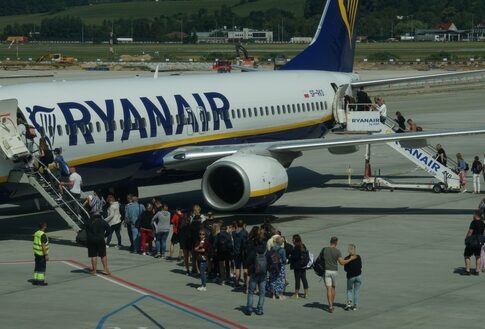Passengers boarding a plane at the airport.