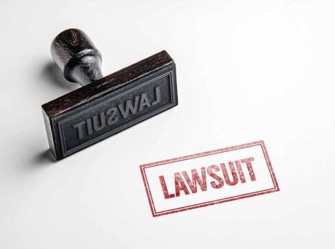 Lawsuit stamp and ink impression on white surface.