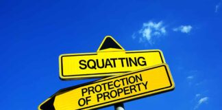 Two conflicting road signs: Squatting and Protection of Property.