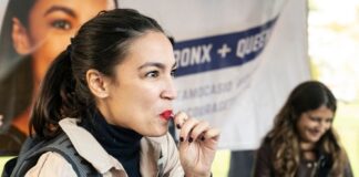 Woman eating candy at outdoor event.