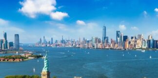 Statue of Liberty with New York City skyline background.