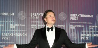 Person in tuxedo posing at Breakthrough Prize event
