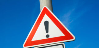 Warning sign with exclamation mark and text .
