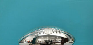 Silver NFL MVP trophy on display.