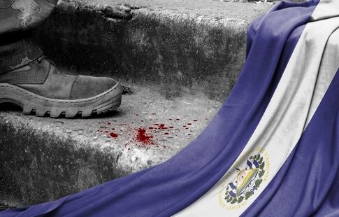 Boot, blood, and El Salvador flag on steps.