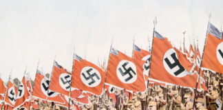 Nazi soldiers marching with swastika flags, World War II