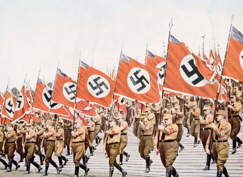 Nazi soldiers marching with swastika flags, World War II
