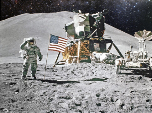 Astronaut saluting by American flag on the moon.