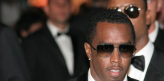 Man in suit and sunglasses at formal event