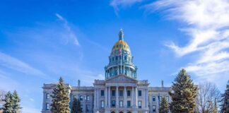 State capitol building with golden dome under blue sky.