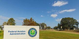 Federal Aviation Administration sign on spacious, grassy lawn.