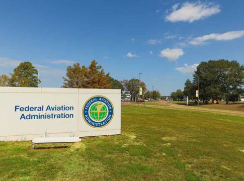 Federal Aviation Administration sign on spacious, grassy lawn.