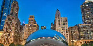 The Bean sculpture in Chicago cityscape at dusk.