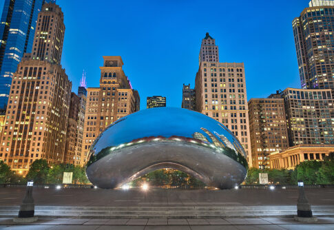 The Bean sculpture in Chicago cityscape at dusk.