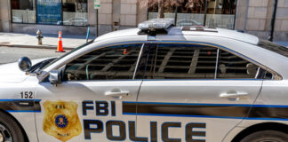 FBI police car parked on city street.