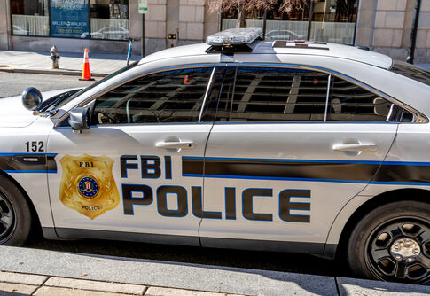 FBI police car parked on city street.