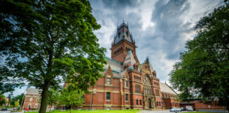 Red-brick, Gothic-style building with a prominent tower.