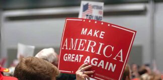 Person holding a Make America Great Again sign.
