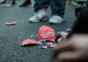 Broken "Make America Great Again" hat on the ground.