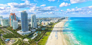 Aerial view of Miami Beach coastline and skyscrapers.