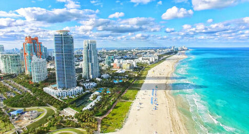 Aerial view of Miami Beach coastline and skyscrapers.
