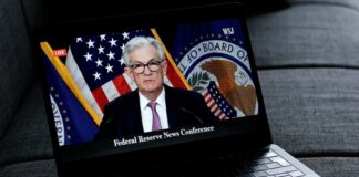 Federal Reserve Chairman speaking at a news conference, televised.