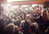 Crowd with phones at an event indoors