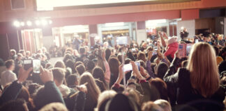 Crowd with phones at an event indoors