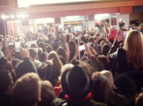Crowd with phones at an event indoors