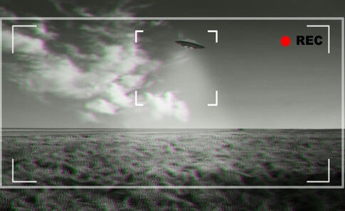 Black and white footage of UFO over a field.