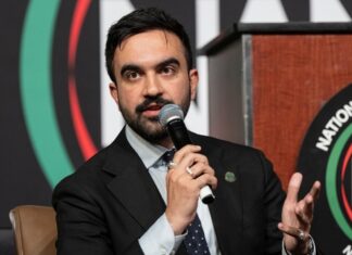 A man speaking into a microphone at a conference