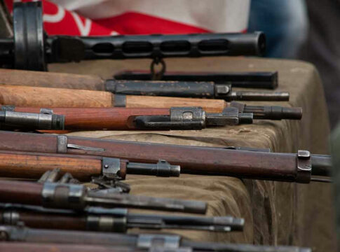 Old rifles displayed on a table