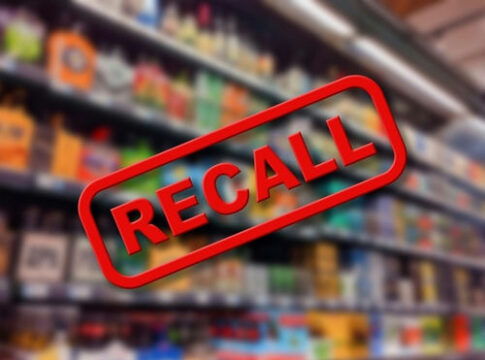 Recall sign over blurred grocery store shelves