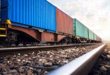 SEALED Boxcar DEATH TRAP — Six Bodies Found… Train with colorful cargo containers on railway track.