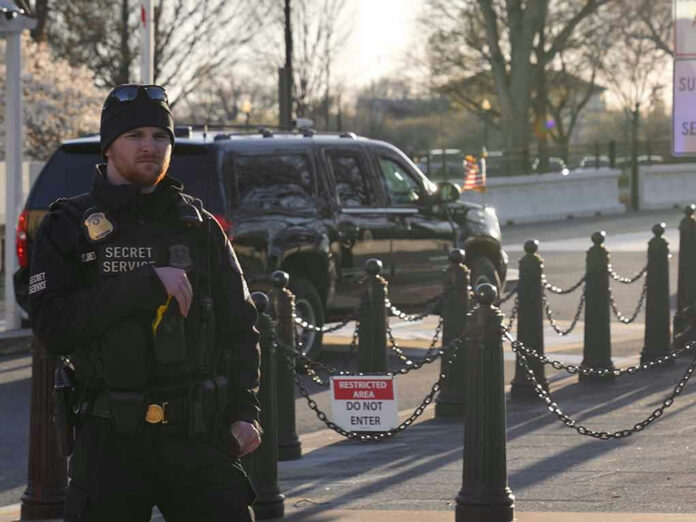 2437164853 Secret Service agent standing near restricted area sign.