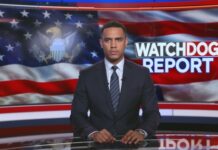 WATCH: National Denial, Video Teases Something Dark… News anchor presenting a report in front of an American flag backdrop