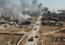 Ukraine Claims 600 Square Kilometers Recaptured — Reuters Can’t Verify It Aerial view of a war-torn city with smoke rising from buildings