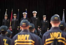 The Viral Claim About Mamdani and the Navy — What the Record Actually Shows Navy officers stand at attention on stage during a ceremony