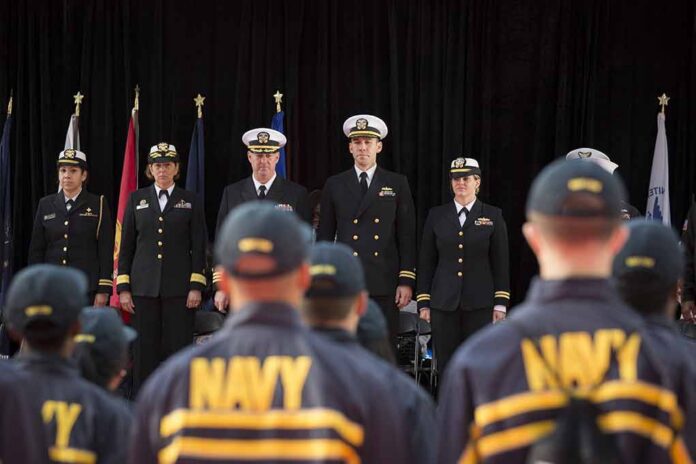 shutterstock_345824741 Navy officers stand at attention on stage during a ceremony